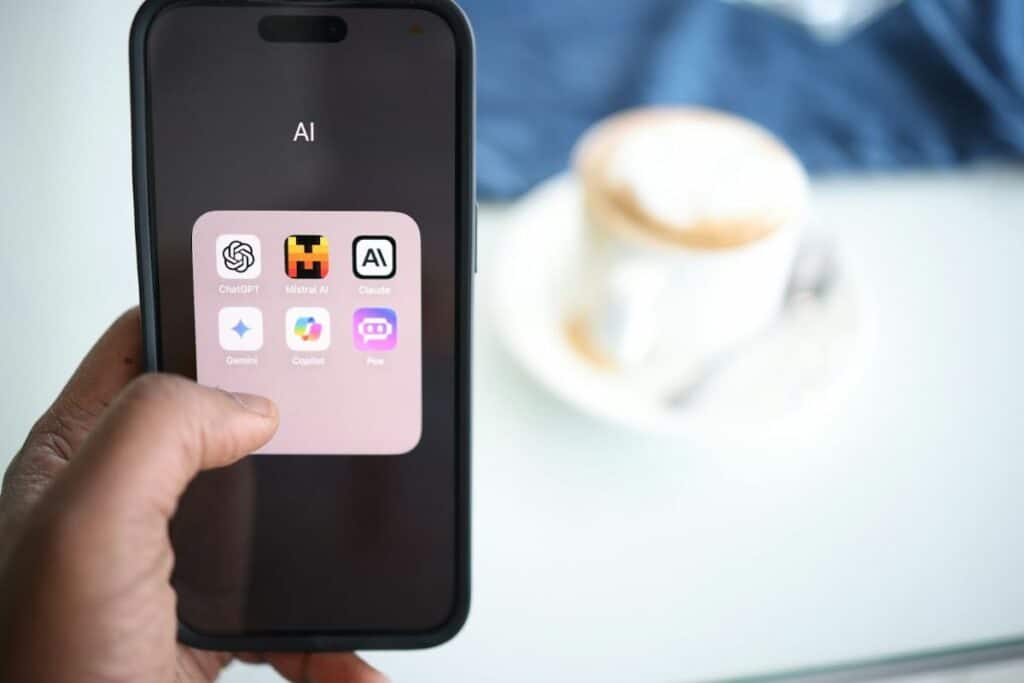A smartphone displaying various AI applications for travel and hospitality, including ChatGPT, Claude, Gemini, and others.
