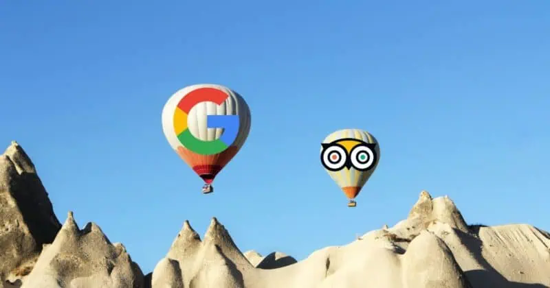 Hot air balloons floating over rocky landscape - one with Google logo design, another with cartoon owl face design.